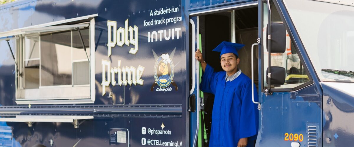 Giovani, a Polytechnic High School senior, stands at the entrance of the food truck he runs as part of the Intuit Food Truck program